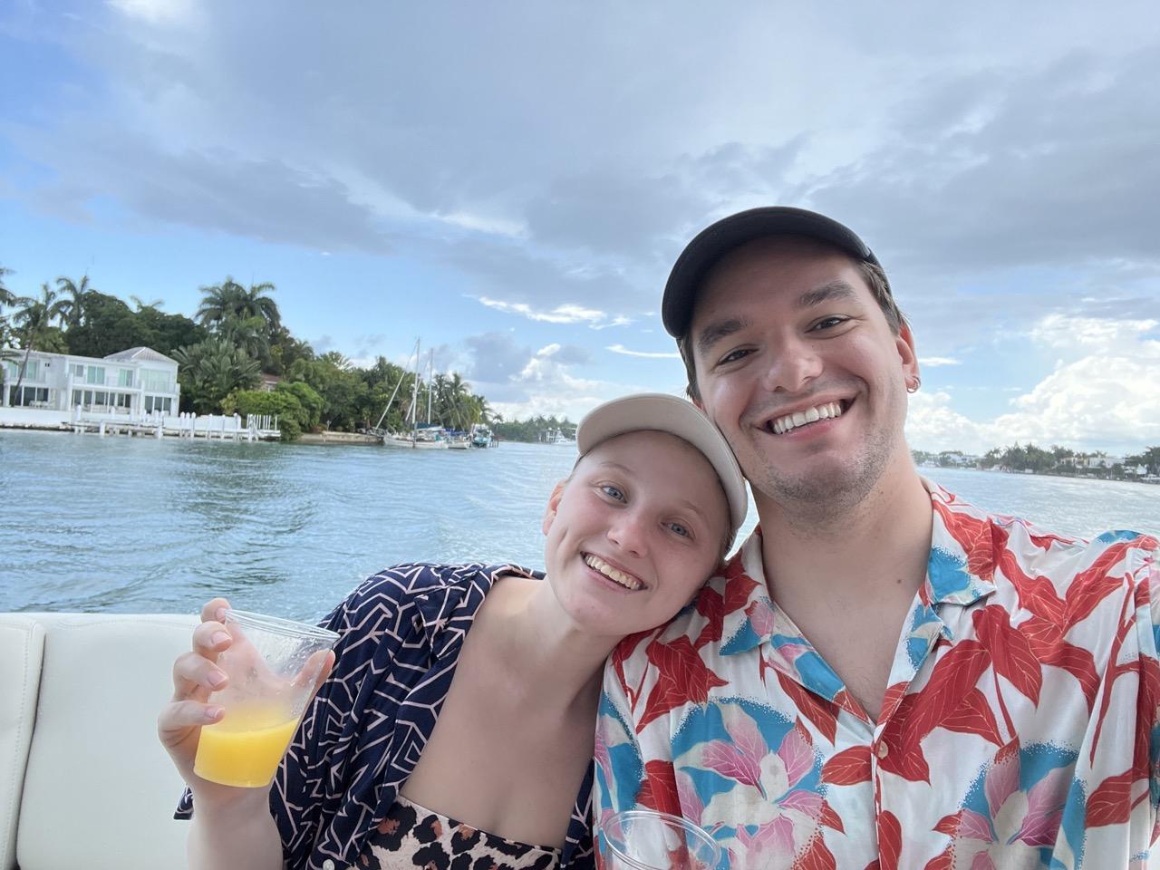 emily and clay drinking mimosas on a boat